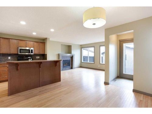 6 Cranberry Place Se, Calgary, AB - Indoor Photo Showing Kitchen With Fireplace