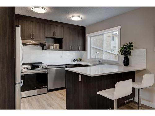 11 Millrose Place Sw, Calgary, AB - Indoor Photo Showing Kitchen With Upgraded Kitchen