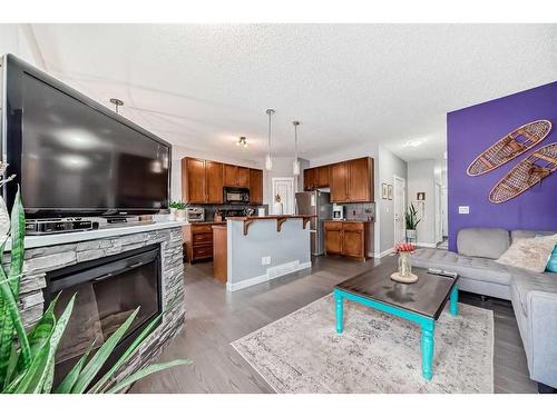 264 Rockyspring Grove Nw, Calgary, AB - Indoor Photo Showing Living Room With Fireplace