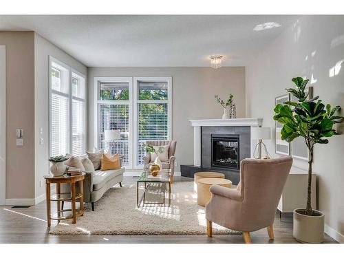 65 Discovery Ridge Road Sw, Calgary, AB - Indoor Photo Showing Living Room With Fireplace