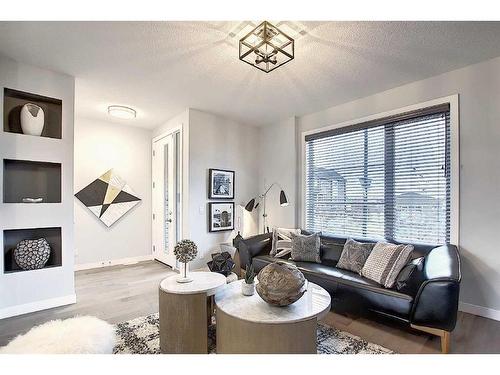 306 Sundown Road, Cochrane, AB - Indoor Photo Showing Living Room With Fireplace