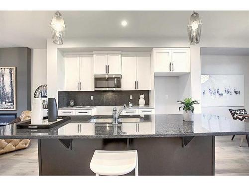 306 Sundown Road, Cochrane, AB - Indoor Photo Showing Kitchen With Double Sink With Upgraded Kitchen