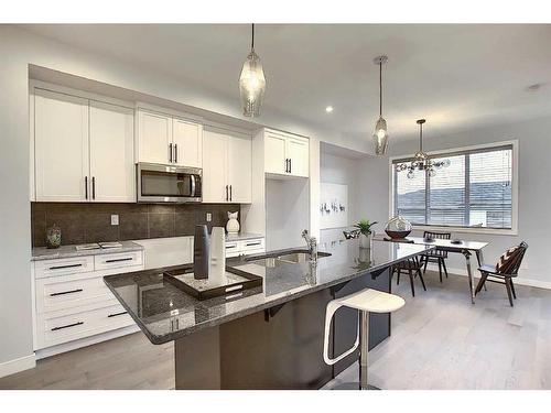 306 Sundown Road, Cochrane, AB - Indoor Photo Showing Kitchen With Upgraded Kitchen