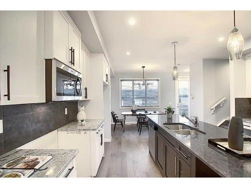 306 Sundown Road, Cochrane, AB - Indoor Photo Showing Kitchen With Double Sink With Upgraded Kitchen