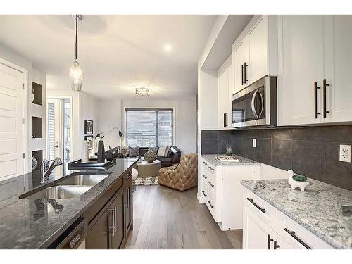 306 Sundown Road, Cochrane, AB - Indoor Photo Showing Kitchen With Double Sink With Upgraded Kitchen