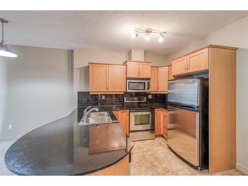 2609-11811 Lake Fraser Drive Se, Calgary, AB - Indoor Photo Showing Kitchen With Stainless Steel Kitchen With Double Sink