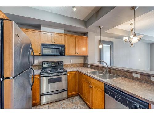 218-208 Holy Cross Sw, Calgary, AB - Indoor Photo Showing Kitchen With Double Sink