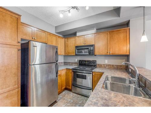 218-208 Holy Cross Sw, Calgary, AB - Indoor Photo Showing Kitchen With Double Sink