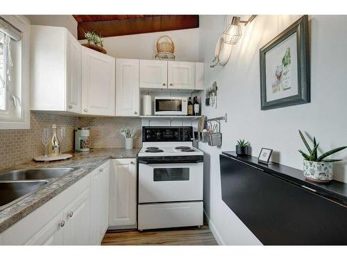 86A Queen Alexandra Close Se, Calgary, AB - Indoor Photo Showing Kitchen With Double Sink