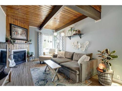 86A Queen Alexandra Close Se, Calgary, AB - Indoor Photo Showing Living Room With Fireplace