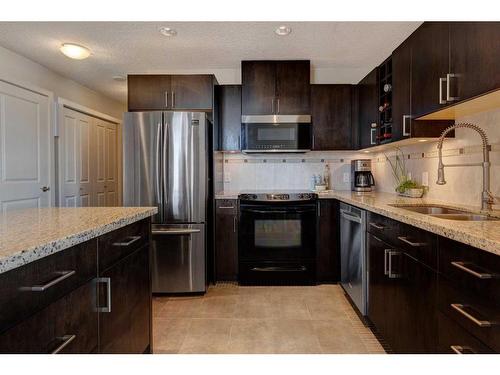 1006-77 Spruce Place Sw, Calgary, AB - Indoor Photo Showing Kitchen With Stainless Steel Kitchen With Double Sink