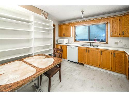 103 Sandstone Way Nw, Calgary, AB - Indoor Photo Showing Kitchen With Double Sink