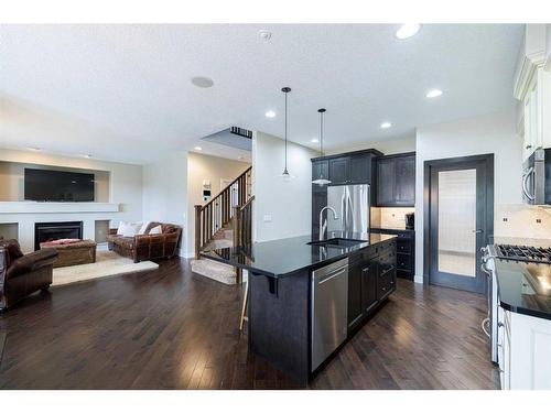 59 Tuscany Glen Place, Calgary, AB - Indoor Photo Showing Kitchen With Fireplace With Stainless Steel Kitchen With Upgraded Kitchen