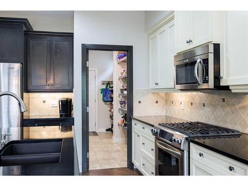 59 Tuscany Glen Place, Calgary, AB - Indoor Photo Showing Kitchen With Stainless Steel Kitchen With Double Sink With Upgraded Kitchen