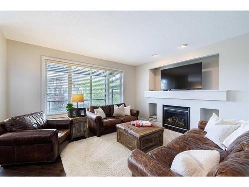 59 Tuscany Glen Place, Calgary, AB - Indoor Photo Showing Living Room With Fireplace