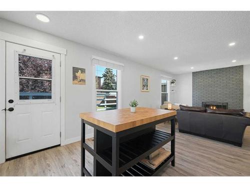 108 Cantrell Drive Sw, Calgary, AB - Indoor Photo Showing Living Room With Fireplace