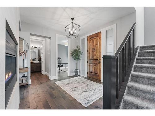 100 Cranbrook Heights Se, Calgary, AB - Indoor Photo Showing Other Room With Fireplace