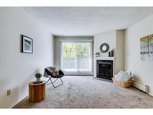 8202-315 Southampton Drive Sw, Calgary, AB - Indoor Photo Showing Living Room With Fireplace