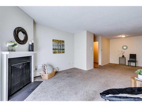 8202-315 Southampton Drive Sw, Calgary, AB - Indoor Photo Showing Living Room With Fireplace