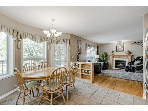 414 Sierra Madre Court Sw, Calgary, AB - Indoor Photo Showing Dining Room With Fireplace