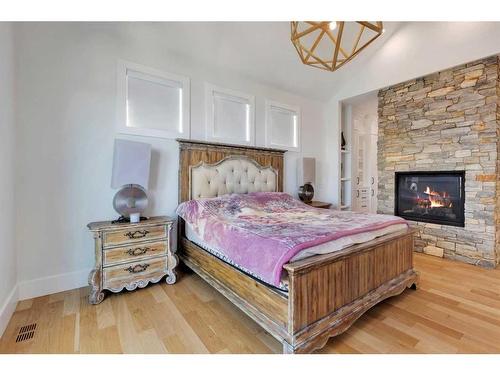 580 Marine Drive Se, Calgary, AB - Indoor Photo Showing Bedroom With Fireplace