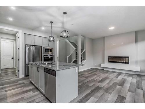 157 Belmont Villas Sw, Calgary, AB - Indoor Photo Showing Kitchen With Fireplace With Stainless Steel Kitchen With Upgraded Kitchen