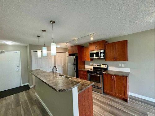 2103-700 Willowbrook Road Nw, Airdrie, AB - Indoor Photo Showing Kitchen With Stainless Steel Kitchen