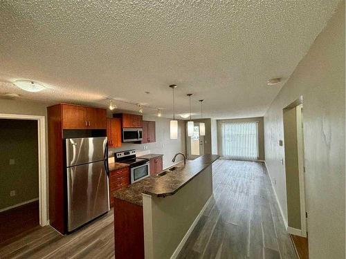 2103-700 Willowbrook Road Nw, Airdrie, AB - Indoor Photo Showing Kitchen With Stainless Steel Kitchen