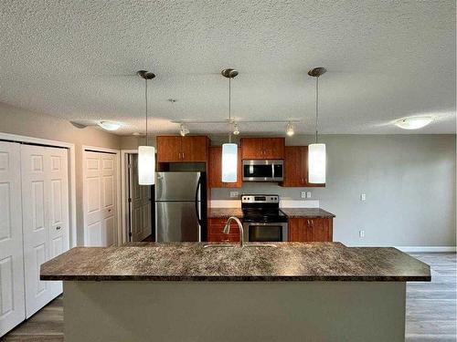 2103-700 Willowbrook Road Nw, Airdrie, AB - Indoor Photo Showing Kitchen With Upgraded Kitchen