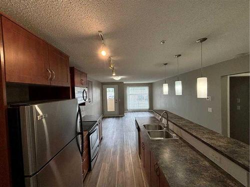 2103-700 Willowbrook Road Nw, Airdrie, AB - Indoor Photo Showing Kitchen With Double Sink