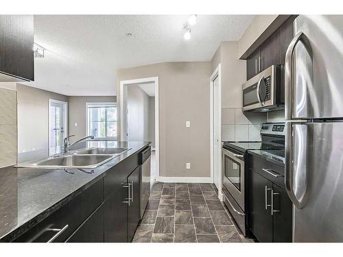 1310-81 Legacy Boulevard Se, Calgary, AB - Indoor Photo Showing Kitchen With Stainless Steel Kitchen With Double Sink