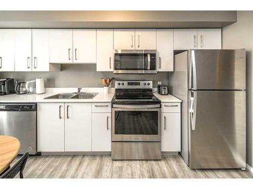 4507-4641 128 Avenue Ne, Calgary, AB - Indoor Photo Showing Kitchen With Double Sink