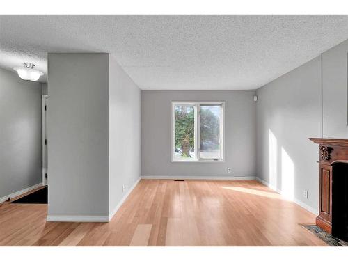 231 Sandstone Road Nw, Calgary, AB - Indoor Photo Showing Other Room With Fireplace