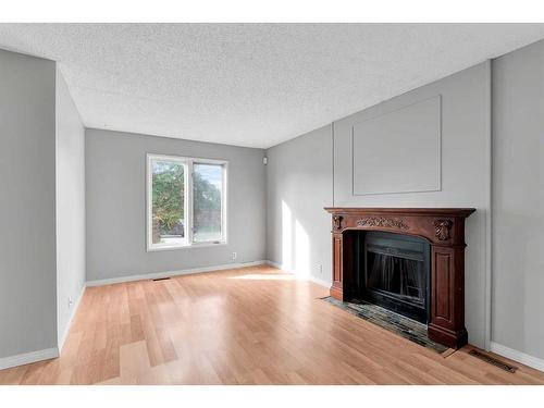 231 Sandstone Road Nw, Calgary, AB - Indoor Photo Showing Living Room With Fireplace