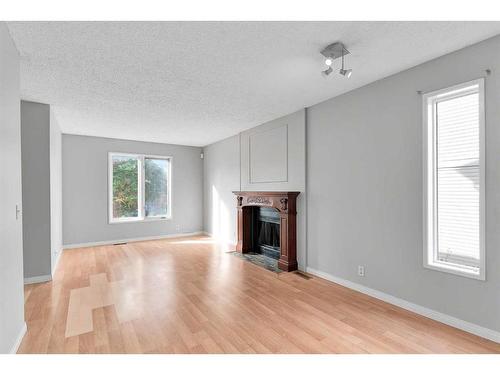 231 Sandstone Road Nw, Calgary, AB - Indoor Photo Showing Living Room With Fireplace