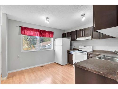 231 Sandstone Road Nw, Calgary, AB - Indoor Photo Showing Kitchen With Double Sink