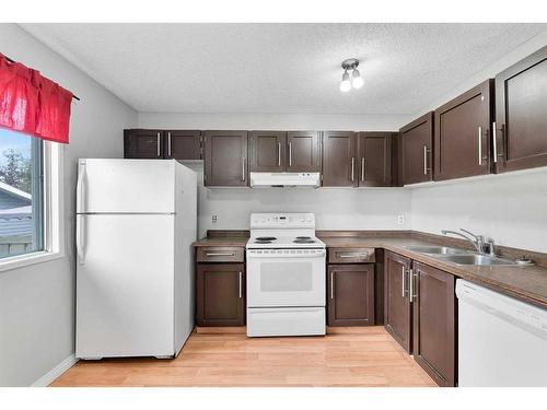 231 Sandstone Road Nw, Calgary, AB - Indoor Photo Showing Kitchen With Double Sink