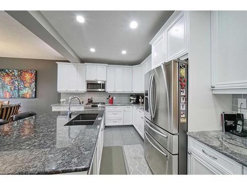 14 Riviera Point, Cochrane, AB - Indoor Photo Showing Kitchen With Double Sink With Upgraded Kitchen