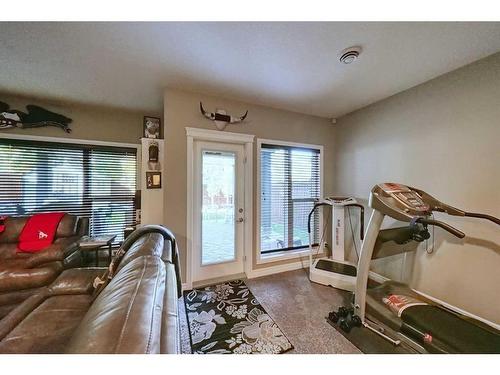 14 Riviera Point, Cochrane, AB - Indoor Photo Showing Gym Room