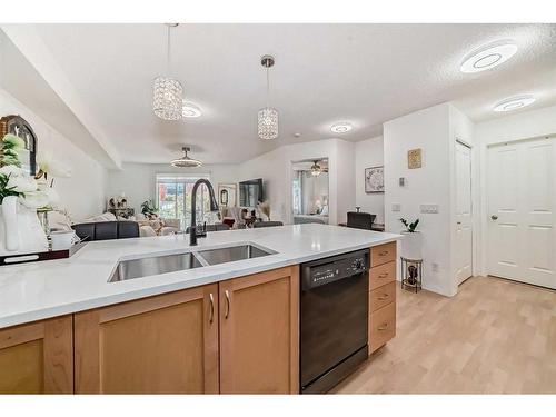 101-380 Marina Drive, Chestermere, AB - Indoor Photo Showing Kitchen With Double Sink