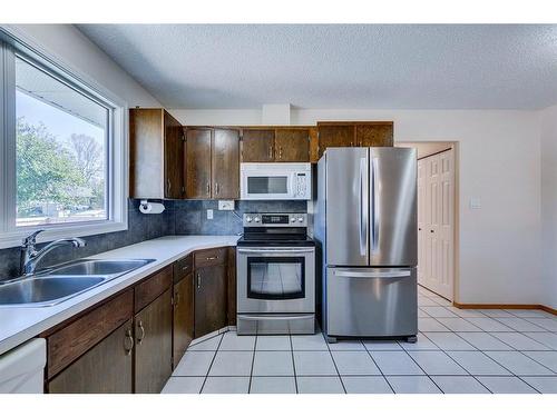 203 Lynnover Place Se, Calgary, AB - Indoor Photo Showing Kitchen With Double Sink