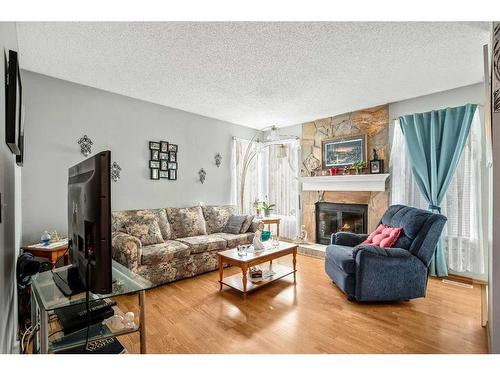 100 Castlegrove Road Ne, Calgary, AB - Indoor Photo Showing Living Room With Fireplace