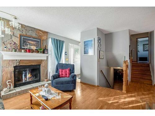 100 Castlegrove Road Ne, Calgary, AB - Indoor Photo Showing Living Room With Fireplace