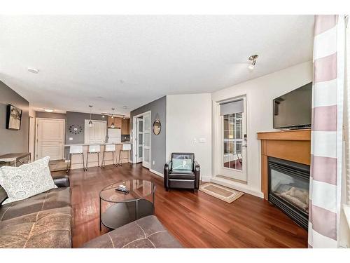 107-5115 Richard Road Sw, Calgary, AB - Indoor Photo Showing Living Room With Fireplace