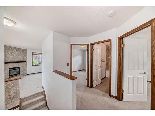 114 Bow Ridge Crescent, Cochrane, AB - Indoor Photo Showing Other Room With Fireplace