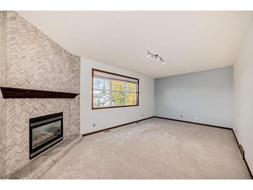 114 Bow Ridge Crescent, Cochrane, AB - Indoor Photo Showing Other Room With Fireplace