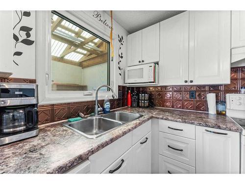 174 Pinemeadow Road Ne, Calgary, AB - Indoor Photo Showing Kitchen With Double Sink