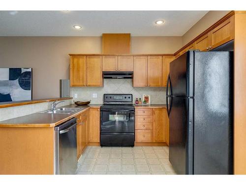 503-2005 Luxstone Boulevard Sw, Airdrie, AB - Indoor Photo Showing Kitchen With Double Sink