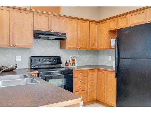 503-2005 Luxstone Boulevard Sw, Airdrie, AB - Indoor Photo Showing Kitchen With Double Sink