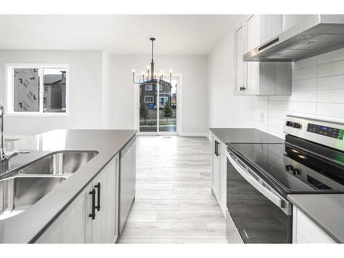 86 Belmont Passage Sw, Calgary, AB - Indoor Photo Showing Kitchen With Double Sink